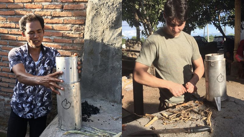 Two-panel field photograph: on the left, a Lombok farmer in a black-and-white floral shirt demonstrating a small stainless-steel Pyropower kiln, freshly finished biochar heaped beside it on the concrete pad; on the right, a young researcher in a green t-shirt loading dried cassava stalks into the same kiln under a tree at another homestead.