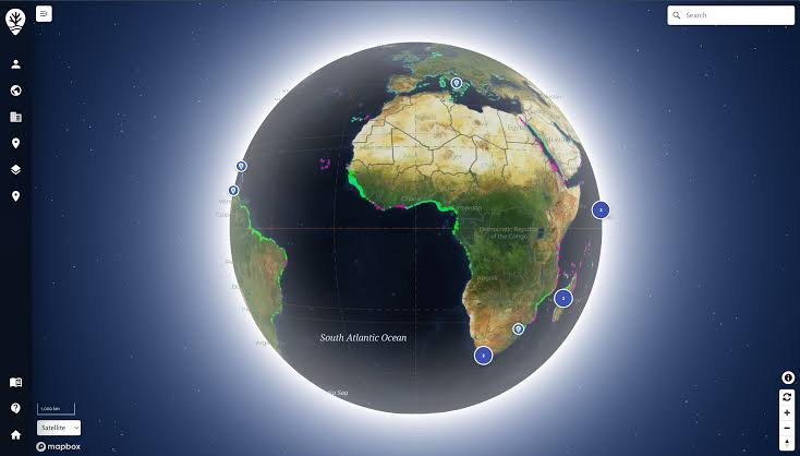Reef Support monitoring platform showing a satellite globe view of Africa and the South Atlantic with numbered pins along the coast marking reef monitoring sites, connected by faint tracks in green and pink along the shoreline.