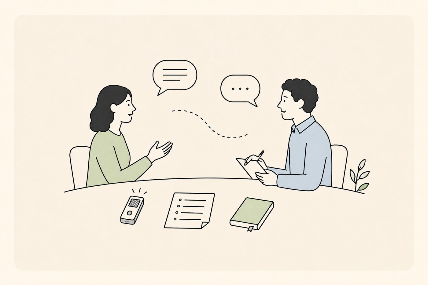 Two-person in-depth interview at a table with a recorder, notes and notebook.